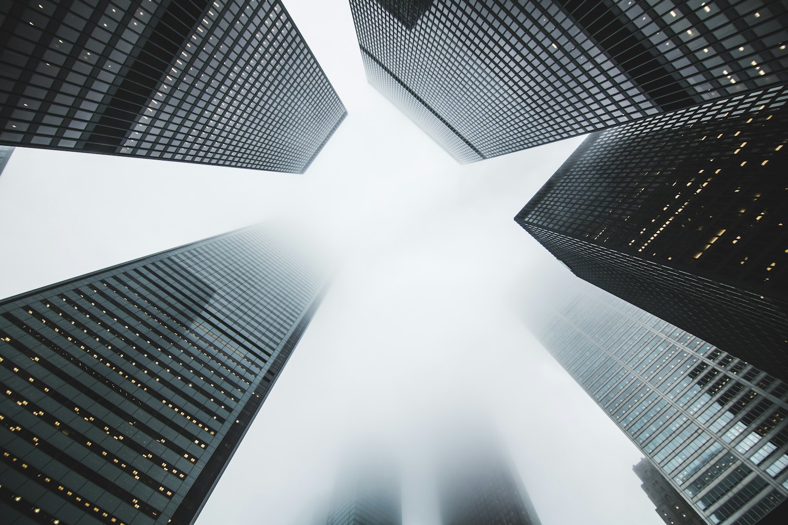 Glass office towers rising into fog